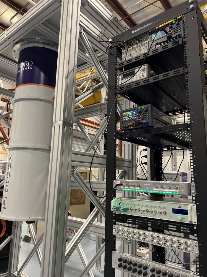 a dark matter detector made of a dilution refrigerator and rack-mount electronics. 