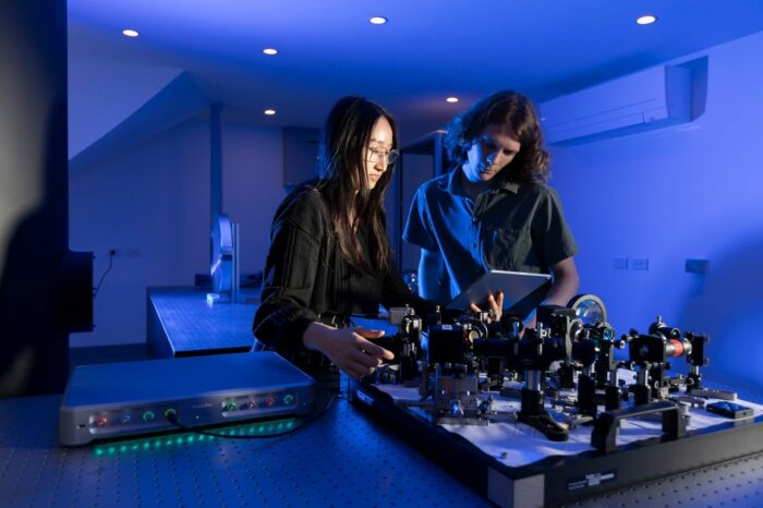 Engineers in a quantum optics laboratory. Engineers in a quantum optics laboratory.